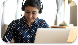 A cheerful employee talking to the client with a headset from the comfort of her home.