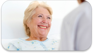 A happy patient talking to the doctor from her hospital bed.